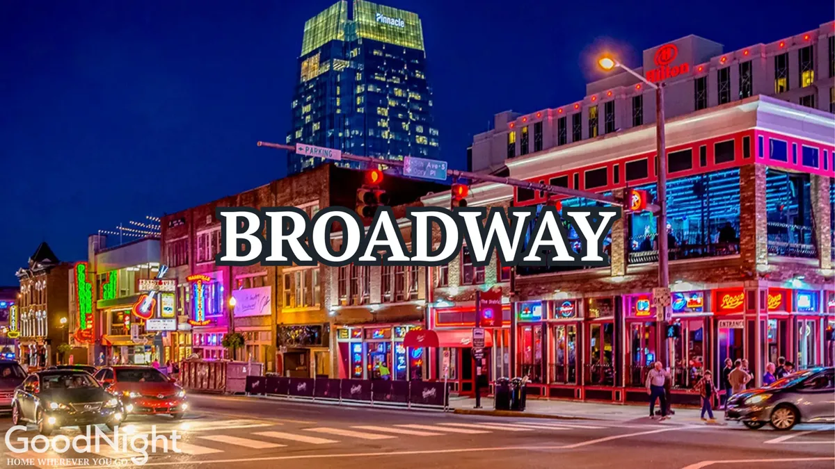 A lively exterior streetscape featuring neon signs, bustling restaurants, theaters, and crowds of people enjoying the energetic nightlife and diverse dining scene of Nashville.